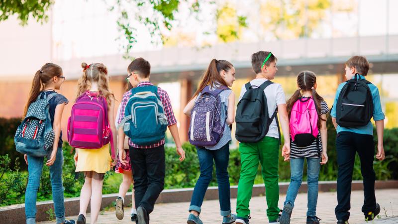 Kids at school wearing backpacks