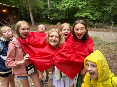 youth girls posing in the rain at camp