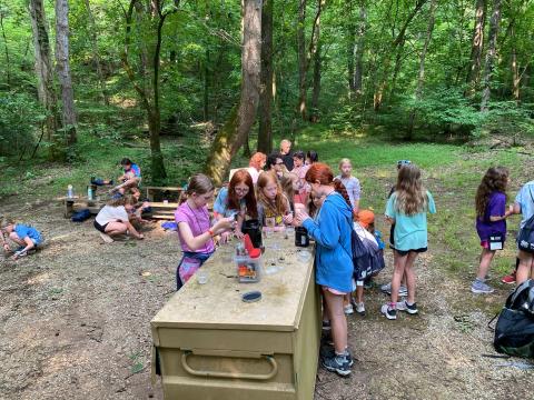 youth girls working on a water filtration project at camp
